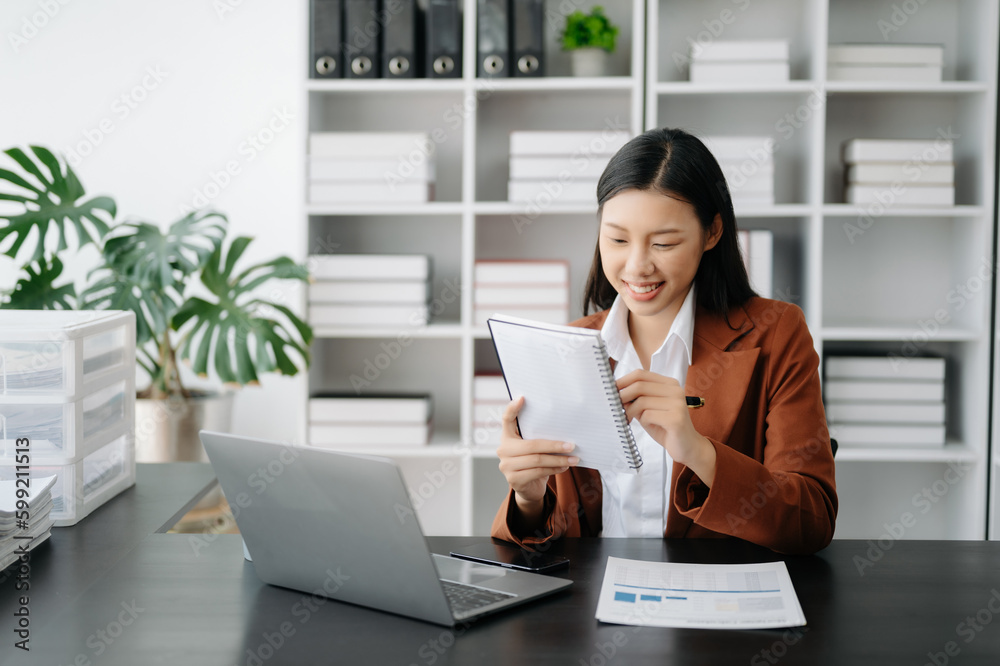 Business woman using tablet and laptop for doing math finance on an office desk, tax, report, accounting, statistics, and analytical research concept in office Business woman using tablet and laptop for doing math finance on an office desk, tax, report, accounting, statistics, and analytical research concept in office