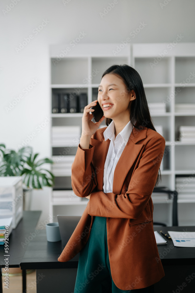Asian business woman have the joy of talking on the smartphone, tablet and laptopon the modern office Asian business woman have the joy of talking on the smartphone, tablet and laptopon the modern office