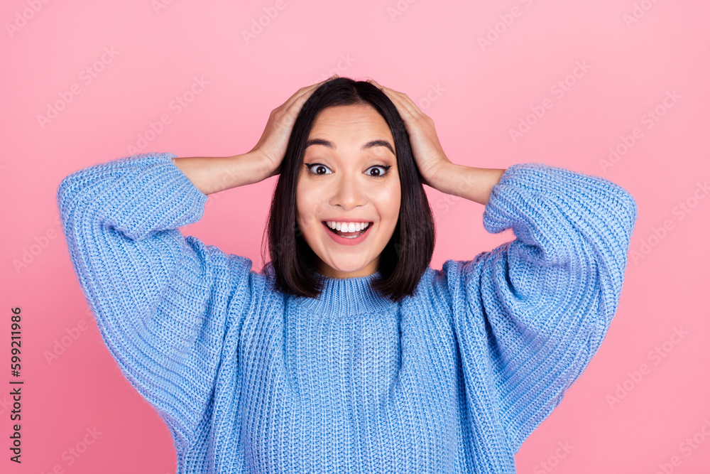 Portrait of astonished impressed girl with bob hairstyle wear blue sweater arms on head staring at sale isolated on pink color background Portrait of astonished impressed girl with bob hairstyle wear blue sweater arms on head staring at sale isolated on pink color background