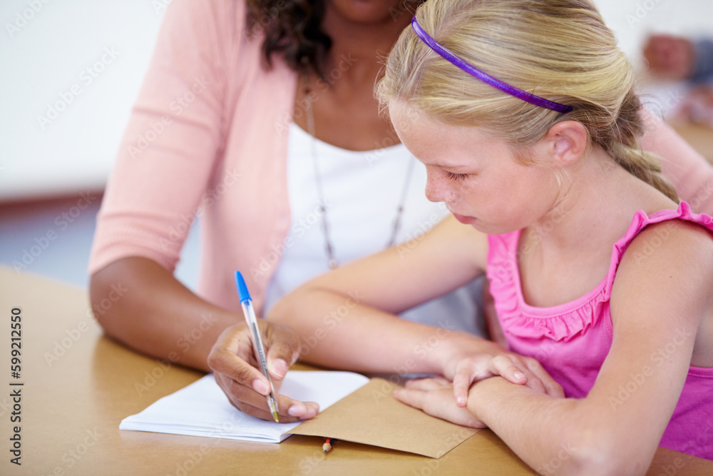 Everyone does well with a little help. a teacher helping a pupil out with her schoolwork. Everyone does well with a little help. a teacher helping a pupil out with her schoolwork.