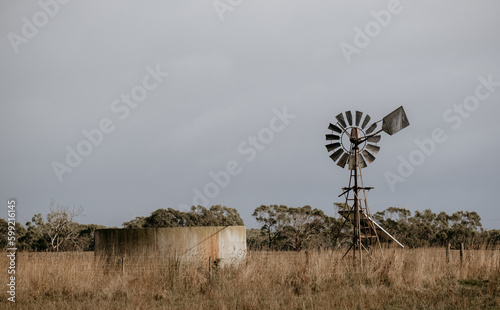 Windmill and water tank on a farm.