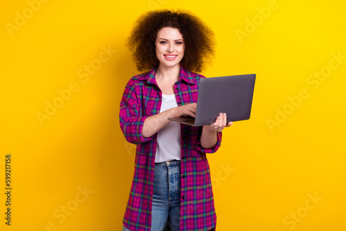 Photo of confident sweet lady wear checkered jacket working modern device isolated yellow color background
