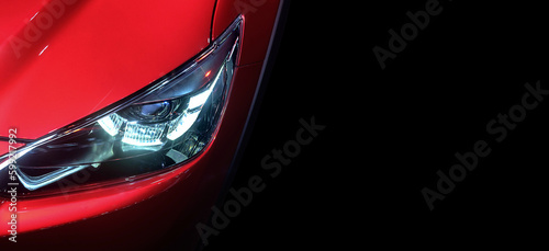 Tableau sur toile Close-up LED xenon headlight on red new modern car on black colour background an