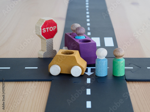 Car accident concept of vehicle insurance. two mini wooden toy cars on the road, incident, car traffic accident. wooden background.