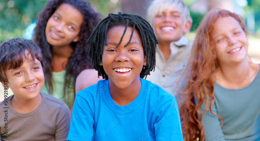 Summer camp fun. A group of happy kids smiling at the camera while sitting outside. Summer camp fun. A group of happy kids smiling at the camera while sitting outside.