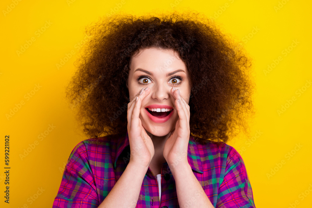 Closeup photo of young funny girl wear checkered shirt screaming breaking news message announce hands cheeks isolated on yellow color background Closeup photo of young funny girl wear checkered shirt screaming breaking news message announce hands cheeks isolated on yellow color background