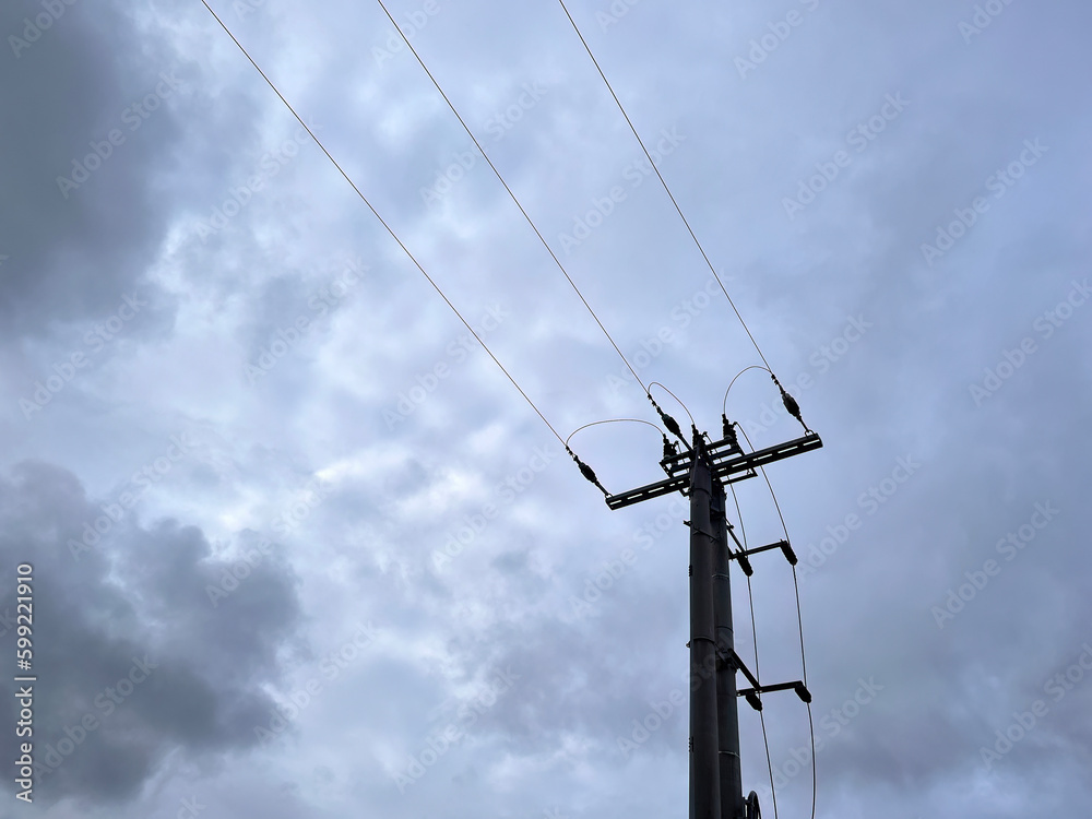 A power pole with a box of wires on it