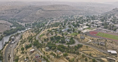 Maupin Oregon Aerial v2 panoramic panning view drone flyover remote small town along the Deschutes river capturing barren canyon landscape on a hazy day - Shot with Mavic 3 Cine - August 2022 photo