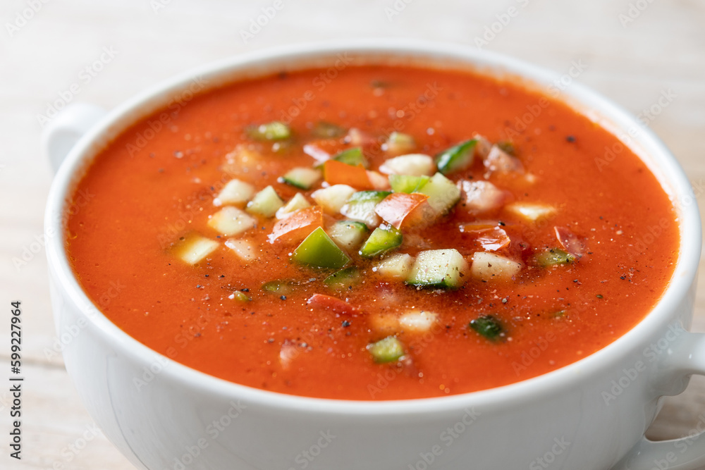 Traditional Spanish gazpacho soup in bowl on wooden table. Close up Traditional Spanish gazpacho soup in bowl on wooden table. Close up