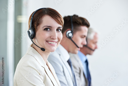 Always here to assist. a beautiful young customer service agent working in an office.