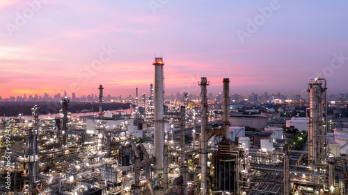 Aerial view oil and gas industry refinery at sunset, Aerial view oil and gas Industrial petrochemical fuel power and energy, Refinery factory oil storage tank and pipeline steel.