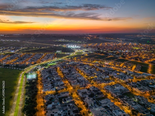 Aerial photography of rush hour traffic in the city of Paulínia, in the interior of São Paulo. Beginning of the night with strong shadows.