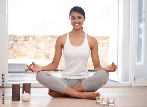 Feeling great physically and mentally. Portrait of an attractive young woman meditating at home.
