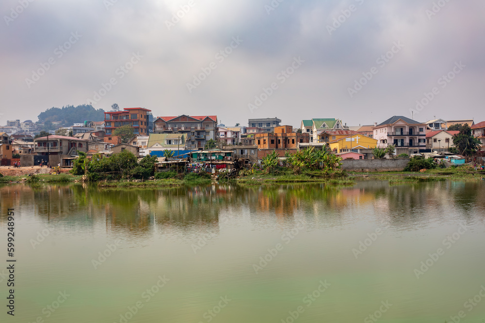 Overcast day in Antananarivo, harsh realities of poverty, with a view of Lake Marais Masai and a residential buildings in the background. Madagascar