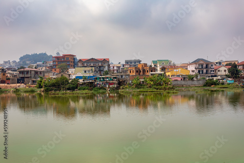 Overcast day in Antananarivo, harsh realities of poverty, with a view of Lake Marais Masai and a residential buildings in the background. Madagascar