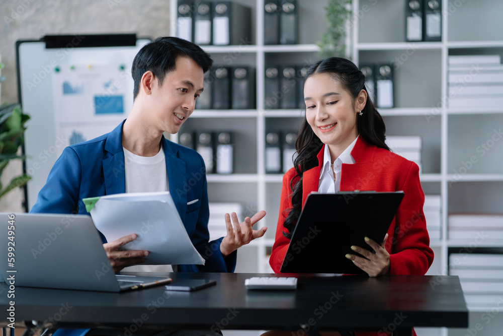 Working on finances together, young asian business couple working on finances at home office. Working on finances together, young asian business couple working on finances at home office.