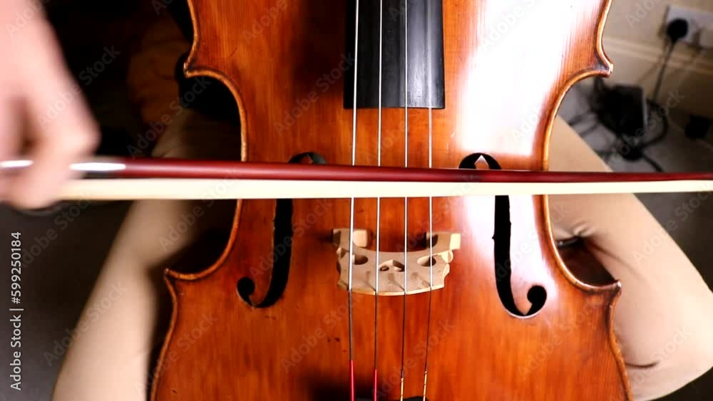 Musician Playing Cello, Bow in Action Musician Playing Cello, Bow in Action