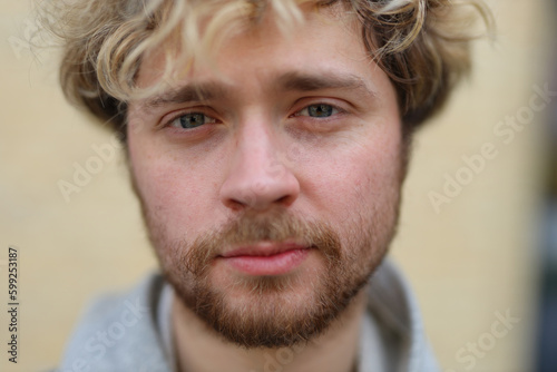 Close-up portrait of a bearded young blond male.