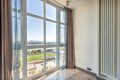 large full wall panoramic window with curtains and lake view