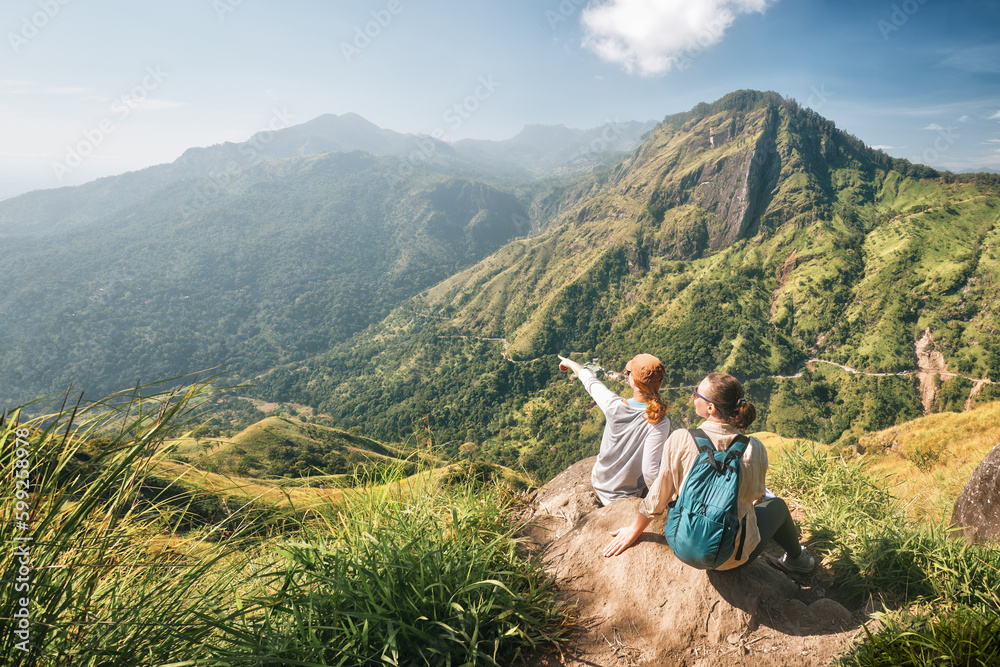 Two traveler friends share emotions on background of mountain peak Two traveler friends share emotions on background of mountain peak