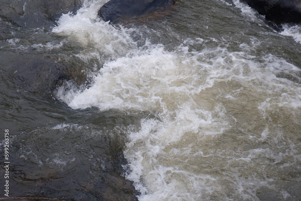 Mountain river with clear water. The rapid flow of a mountain river Mountain river with clear water. The rapid flow of a mountain river