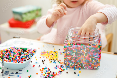 close-up girl playing Hama Beads photo