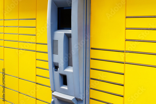 Close-up of Autonomous Yellow Parcel Locker for Delivery, Pick-up, and Payment