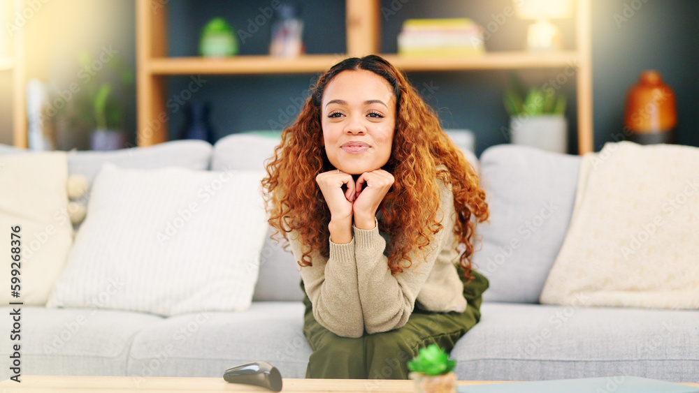 Lady laughing at comedy movie on her online subscription via wifi while sitting on her sofa at home. Young woman switches on tv using remote and enjoys stand up comedy relaxing on the couch indoors Lady laughing at comedy movie on her online subscription via wifi while sitting on her sofa at home. Young woman switches on tv using remote and enjoys stand up comedy relaxing on the couch indoors