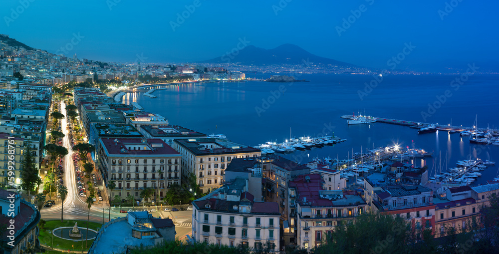 The panorama of Naples in the evening dusk.