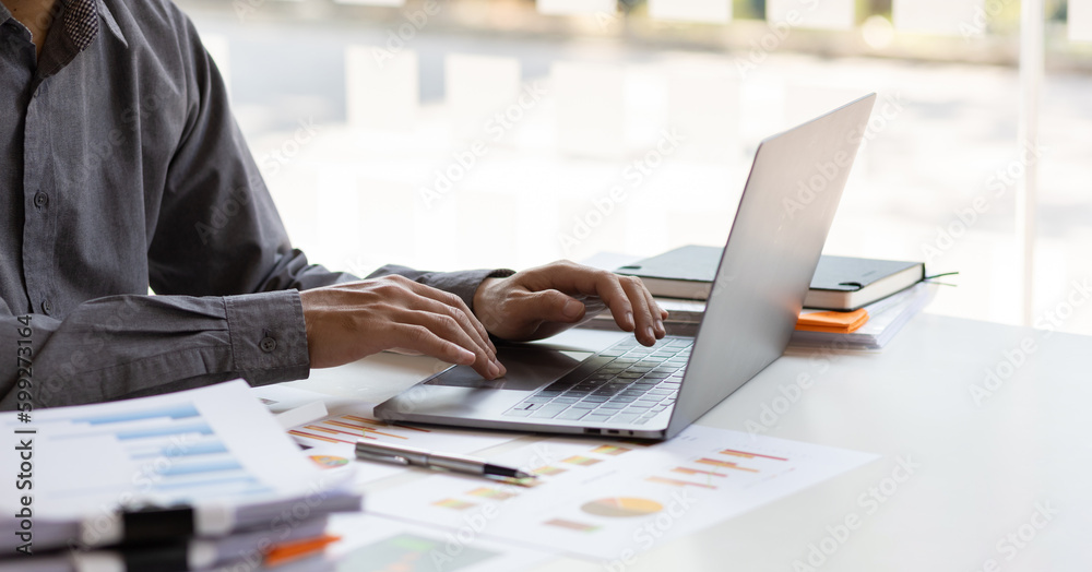 Businessman working with business report papers on office desk, financial chart analysis with calculator and accounting financial statement planning. - obrazy, fototapety, plakaty 
