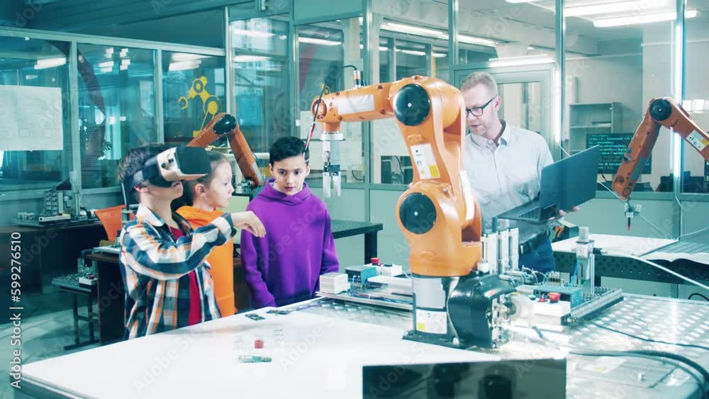 Kids are learning to operate robots with their instructor Kids are learning to operate robots with their instructor