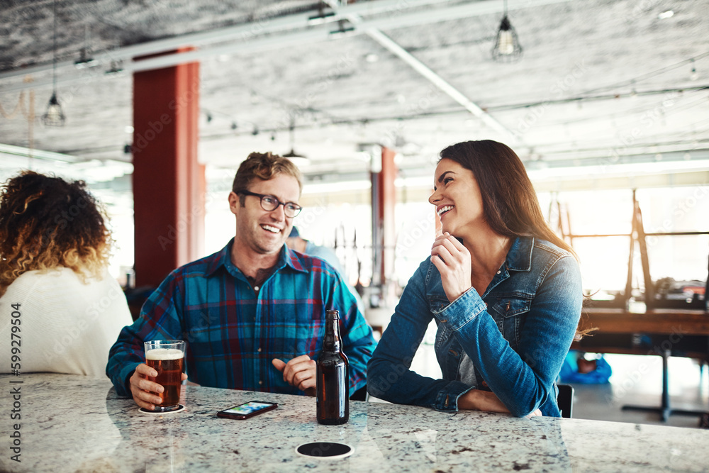 Fototapeta premium What a great way to start the weekend. a couple enjoying a drink at a bar.