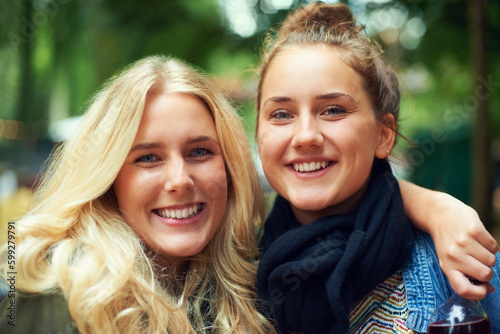 Hitting the festival together this year. Portrait of two attractive young women standing together outdoors.
