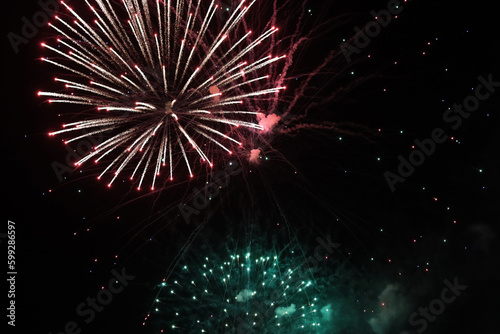 Colorful fireworks of various colors over night sky, celebration and anniversary concept