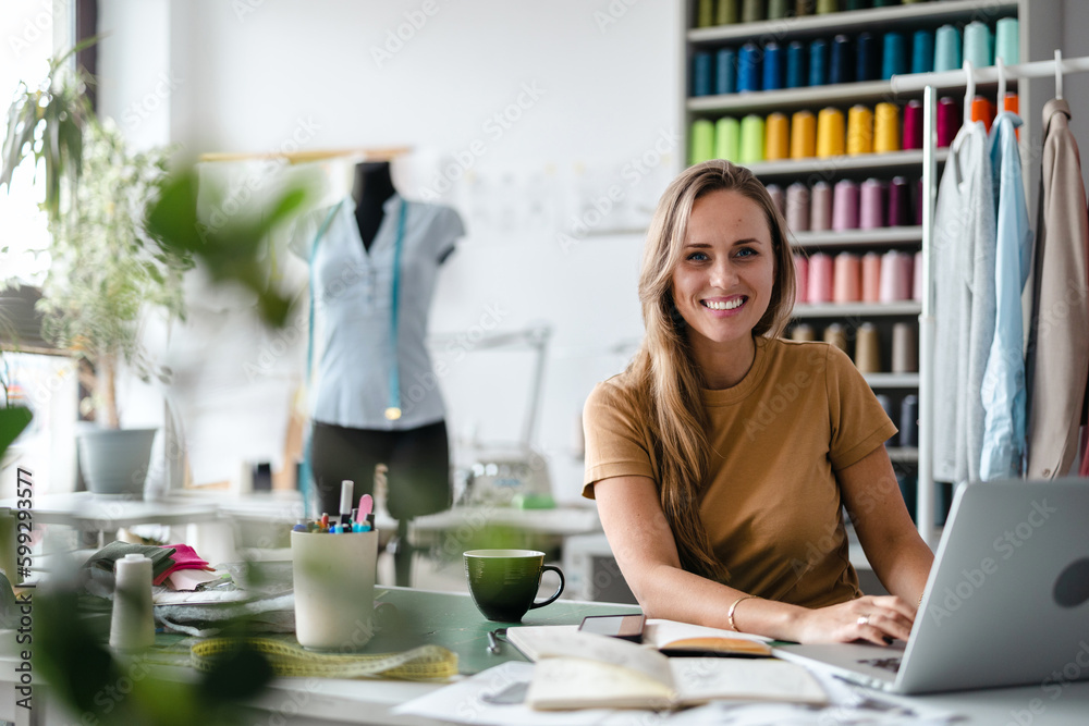 Young fashion designer at her workplace
