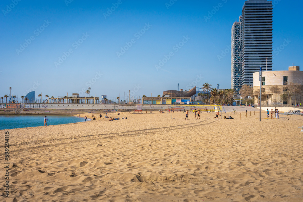Beach in Barcelona Spain with people exercising on a beautiful Spring day