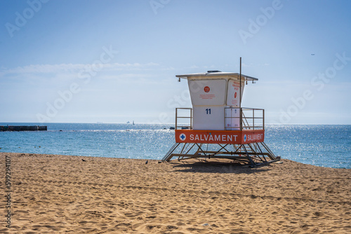Barcelona Spain beach with a lifeguard tower and clear blue sky © crazymonkstudio