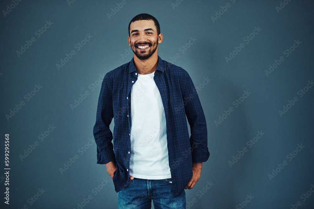 Professional and confident. Studio portrait of a confident man posing against a gray background. Professional and confident. Studio portrait of a confident man posing against a gray background.
