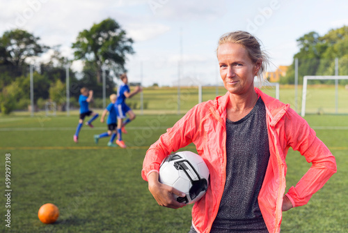 Portrait of woman holding soccer ball
