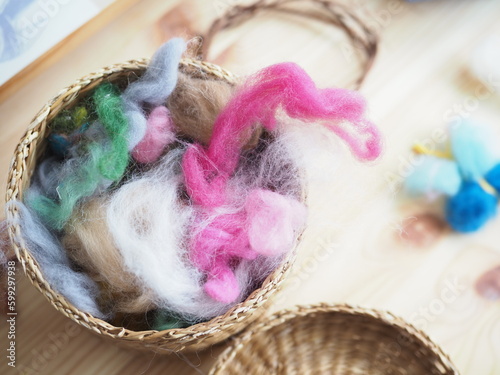 basket with a set of colored wool for felting
