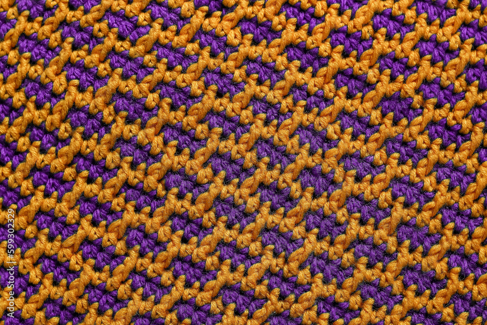 Knitted background. Seamless purple yellow crochet fabric with brick pattern.