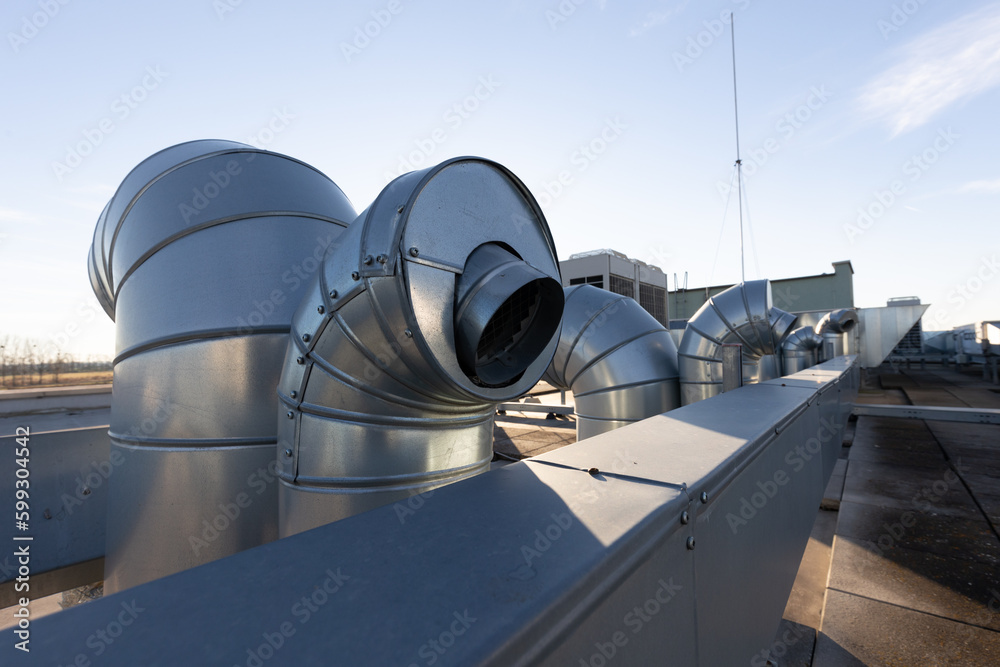External unit of commercial air conditioning and ventilation system  installed on industrial building roof. Exhaust vent on flat factory rooftop  Stock Photo | Adobe Stock