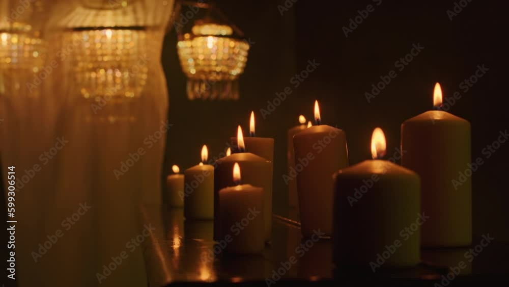 In the darkness, a witch performs a mystic rite with black candles and voodoo magic. A close-up of the piano accentuates the mysticism and paganism of the ritual. In the darkness, a witch performs a mystic rite with black candles and voodoo magic. A close-up of the piano accentuates the mysticism and paganism of the ritual.
