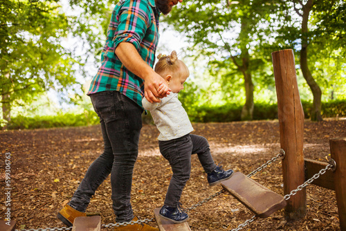 Father with daughter (2-3) in playground