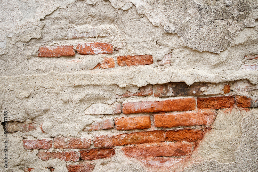 very cracked old wall background texture with red bricks inside very cracked old wall background texture with red bricks inside
