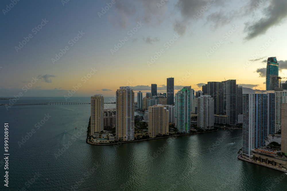 View from above of high skyscraper buildings in downtown district of Miami Brickell in Florida, USA at sunset. American megapolis with business financial district at nightfall