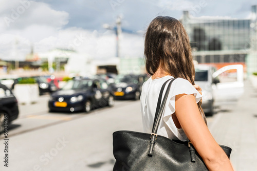 Woman with shoulder bag in city street