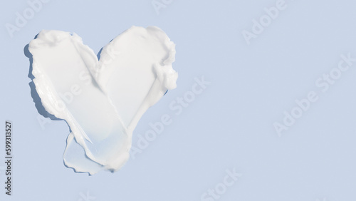 Beauty skincare cream texture swipe swatch in heart shaped. White beauty cream smear smudge isolated on blue background photo