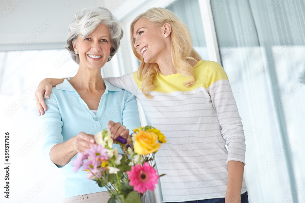 Learning from the master. Portrait of a senior woman enjoying some flower arranging with her daughter. Learning from the master. Portrait of a senior woman enjoying some flower arranging with her daughter.
