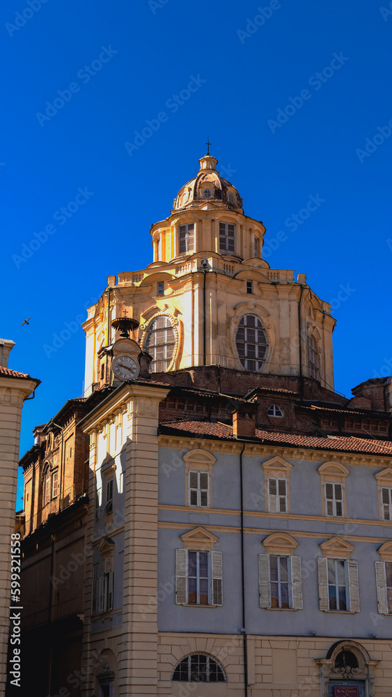 
Real Church of San Lorenzo on the background of Piazza Castello in the center of Turin on a sunny spring day